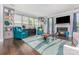 Elegant living room with a fireplace, built-in shelves, blue accents, and hardwood flooring at 10203 Loch Lomond Dr, Charlotte, NC 28278