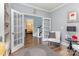 A versatile living room featuring French doors and view to staircase at 10203 Loch Lomond Dr, Charlotte, NC 28278