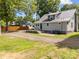 Exterior back of the property with patio, gravel driveway, and lush surroundings at 1025 Old Us 80 Hwy, Gold Hill, NC 28071