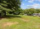 Lush backyard with mature trees, offering ample space for outdoor activities and landscaping possibilities at 1025 Old Us 80 Hwy, Gold Hill, NC 28071