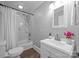 Bathroom featuring a shower-tub combo with white tile surround and updated vanity with white basin at 1025 Old Us 80 Hwy, Gold Hill, NC 28071