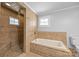 Bathroom featuring a shower and separate tub with tiled surround and decorative inlays at 1025 Old Us 80 Hwy, Gold Hill, NC 28071