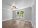 Bedroom featuring fresh paint, updated flooring, and multiple windows offering ample natural light at 1025 Old Us 80 Hwy, Gold Hill, NC 28071