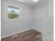 Walk-in closet featuring painted shelving, wood look floors and a window for natural light at 1025 Old Us 80 Hwy, Gold Hill, NC 28071