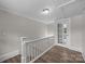 Hallway boasts hardwood floors, white walls and trim, and a door to an attic space at 1025 Old Us 80 Hwy, Gold Hill, NC 28071
