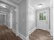 Hallway featuring fresh paint and updated flooring leading to a front door with glass inserts at 1025 Old Us 80 Hwy, Gold Hill, NC 28071