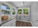 Bright laundry room with granite countertop, wood-look floors, and multiple windows offering natural light at 1025 Old Us 80 Hwy, Gold Hill, NC 28071