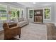 Cozy living room with a decorative fireplace, comfortable seating, and large windows overlooking the outdoors at 1025 Old Us 80 Hwy, Gold Hill, NC 28071