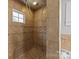 Shower stall featuring tiled surround with decorative inlays and shower head at 1025 Old Us 80 Hwy, Gold Hill, NC 28071