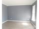 Bedroom featuring a large window, light-colored walls, and modern floors at 10615 Elm Bend Dr, Charlotte, NC 28273
