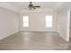 Large primary bedroom with wood look flooring, neutral walls and ample natural light at 10615 Elm Bend Dr, Charlotte, NC 28273