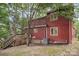 View of the exterior back with a wooden porch and stairs at 110 Hidden Valley St, Cherryville, NC 28021