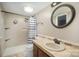 Cozy bathroom featuring a tiled shower with a glass door, vanity with oval mirror, and lighting at 110 Hidden Valley St, Cherryville, NC 28021