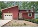 Charming red home featuring a garage and front entrance with a landscaped front yard at 110 Hidden Valley St, Cherryville, NC 28021