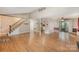 Open-concept living room featuring hardwood floors and views of the staircase and adjacent kitchen at 110 Hidden Valley St, Cherryville, NC 28021