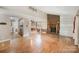 Bright living room showcasing a fireplace, open layout, hardwood floors, and access to the kitchen at 110 Hidden Valley St, Cherryville, NC 28021
