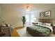 Relaxing bedroom featuring tropical patterned bedding and a cozy reading corner with plants at 12314 Chickasaw Dr, Huntersville, NC 28078