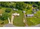 Aerial view of property with well-maintained lawn, outbuildings, and driveway at 124 Island Park Ln, Statesville, NC 28625