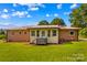 Beautiful backyard with a charming brick house and well-maintained lawn at 124 Island Park Ln, Statesville, NC 28625