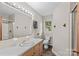 Bright bathroom with a large mirror, vanity, and shower at 124 Island Park Ln, Statesville, NC 28625