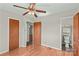 Neutral bedroom showcasing hardwood flooring, doors and a ceiling fan with lighting at 124 Island Park Ln, Statesville, NC 28625