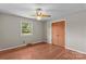 Light-filled bedroom with hardwood floors, window and a ceiling fan at 124 Island Park Ln, Statesville, NC 28625