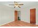 Neutral bedroom features hardwood flooring, ceiling fan and closet door at 124 Island Park Ln, Statesville, NC 28625