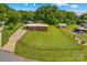 Well-manicured lawn surrounds the property, complemented by an attached carport and outbuilding at 124 Island Park Ln, Statesville, NC 28625