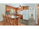 Well-lit kitchen with a breakfast bar, white appliances, and wooden cabinets providing ample storage at 124 Island Park Ln, Statesville, NC 28625