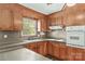 Traditional kitchen featuring wood cabinets, laminate countertops, and built-in oven at 124 Island Park Ln, Statesville, NC 28625