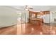Living space featuring hardwood floors flowing into the kitchen with a breakfast bar and sunroom access at 124 Island Park Ln, Statesville, NC 28625