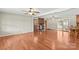 Large living room with hardwood floors, a brick fireplace, and sliding glass doors to the sunroom at 124 Island Park Ln, Statesville, NC 28625