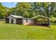 View of the backyard with a metal outbuilding and covered parking area at 124 Island Park Ln, Statesville, NC 28625