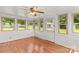 Bright sun room with beadboard walls, wood floors, and multiple windows at 124 Island Park Ln, Statesville, NC 28625