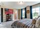 A cozy bedroom with blue curtains and decorative American flag on the wall at 126 Longwood Rd # 52, Mooresville, NC 28115