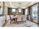Elegant dining room featuring a modern chandelier, tray ceiling, and large windows with patterned curtains at 126 Longwood Rd # 52, Mooresville, NC 28115