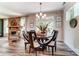Light filled dining room with windows, decor and table with seating near a stacked stone fireplace at 126 Longwood Rd # 52, Mooresville, NC 28115