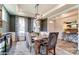 Stylish dining room with tray ceilings, chandelier, and large windows overlooking the backyard at 126 Longwood Rd # 52, Mooresville, NC 28115