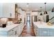 Bright kitchen features stainless steel appliances, pendant lighting, white cabinets and a large island at 126 Longwood Rd # 52, Mooresville, NC 28115