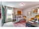 A room with a futon, a desk, and a yellow chair and a rug on the floor at 126 Longwood Rd # 52, Mooresville, NC 28115
