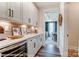 Spacious pantry featuring white cabinets, quartz countertops, and a wine cooler at 126 Longwood Rd # 52, Mooresville, NC 28115