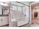 Contemporary shower with white herringbone tile, frameless glass, and convenient bench at 126 Longwood Rd # 52, Mooresville, NC 28115