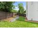 Lush backyard featuring a stone retaining wall and plenty of space for outdoor activities at 129 French St, Charlotte, NC 28216