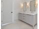 Bathroom with double vanity, marble countertops, framed mirrors, and sconce lighting at 129 French St, Charlotte, NC 28216