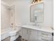 Bathroom with marble shower, tile flooring, toilet, and modern gold-tone light fixture at 129 French St, Charlotte, NC 28216