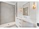 Elegant bathroom featuring a walk-in shower, marble countertop, and modern gold-tone light fixtures at 129 French St, Charlotte, NC 28216