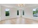 Bright bedroom featuring hardwood floors, neutral walls, and multiple windows offering scenic views at 129 French St, Charlotte, NC 28216