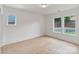 Bright bedroom with hardwood floors, natural light from two windows, and fresh paint at 129 French St, Charlotte, NC 28216