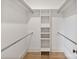 Walk-in closet with built-in shelving and metal hanging rods at 129 French St, Charlotte, NC 28216
