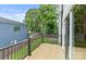 Wooden deck with black railings, providing an outdoor space for relaxation and entertainment at 129 French St, Charlotte, NC 28216
